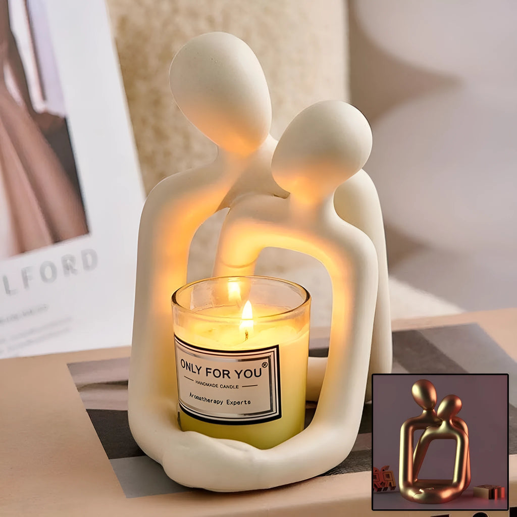 Modern milky white resin statue of a loving couple on a wooden desk.