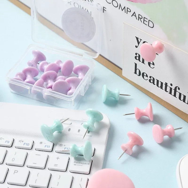 Box of plastic push pins in large and small sizes showing cherry blossom pink, mint green, and lavender colours.
