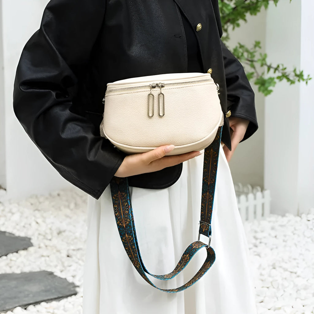 Soft black PU women's saddle-shaped messenger bag with a single crossbody strap and external pocket.