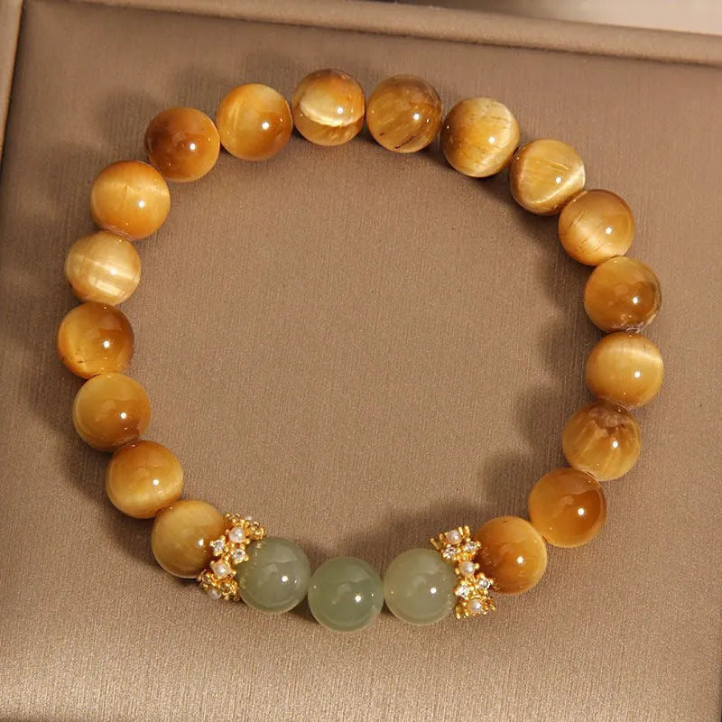 Natural yellow tiger's eye and Hetian jade bead bracelet in a U-shape, showing golden gourd design.