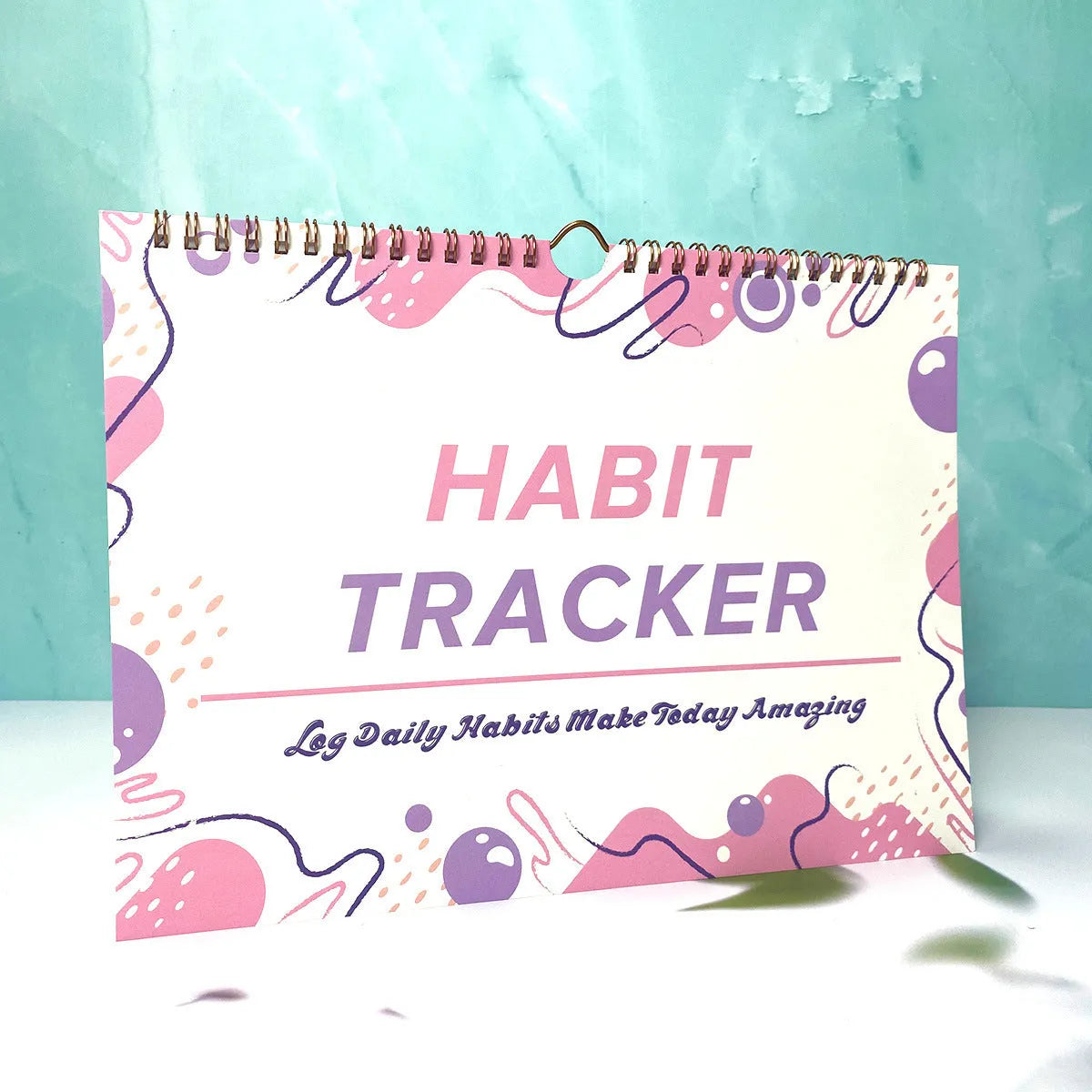 Habit tracking planner showing 12 internal pages in A4 21x28cm size with colour options