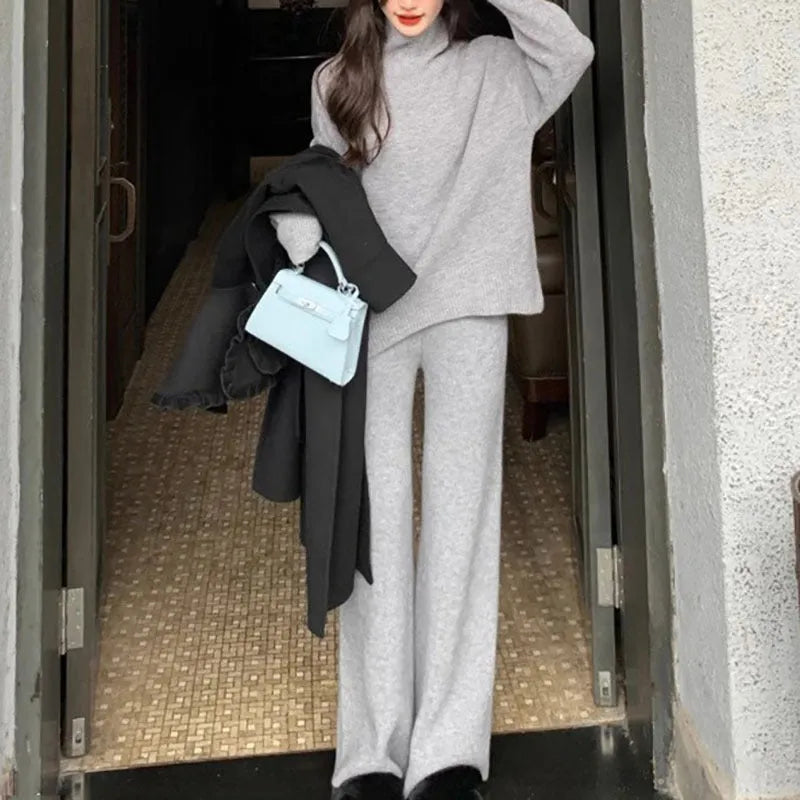 Women's casual two-piece set with an acrylic sweater and wide-leg trousers in a solid colour.