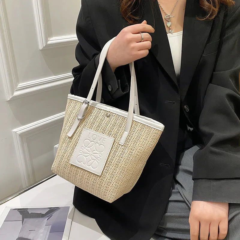 Straw woven women's shoulder bag with retro design showing three-dimensional pockets and 18cm handle