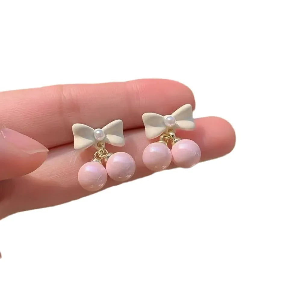 Pink heart pearl bow earrings on alloy with electroplated finish, silver needle style