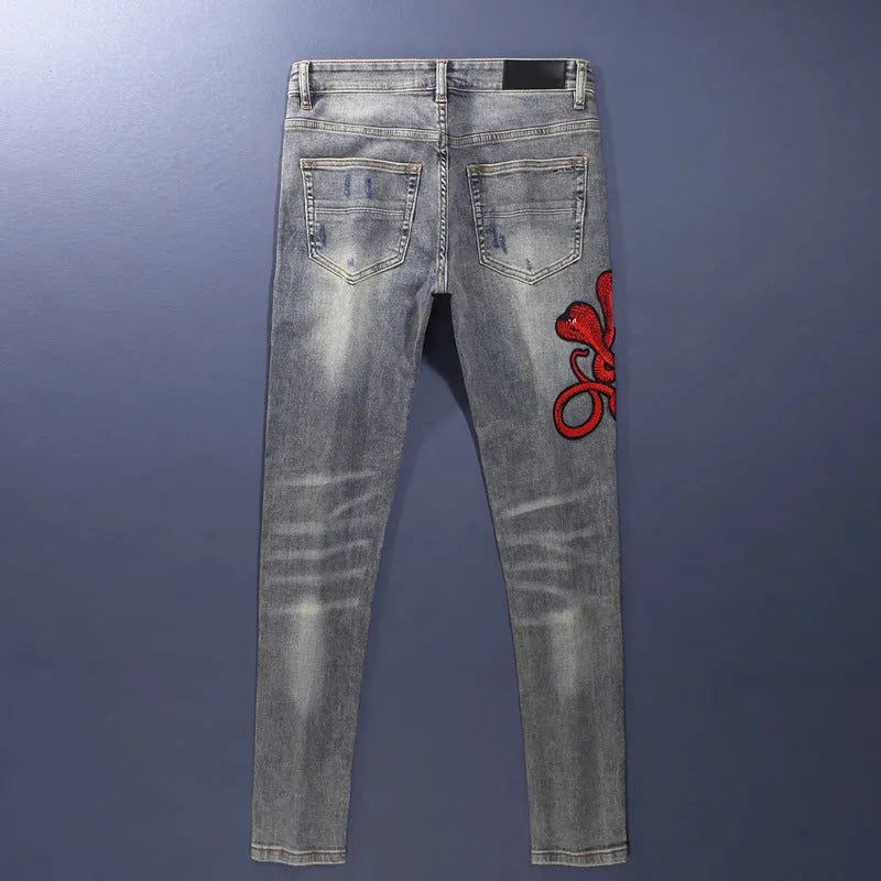 Old colour slim fit jeans with worn looking washed-out finish and trendy hole patch embroidery details