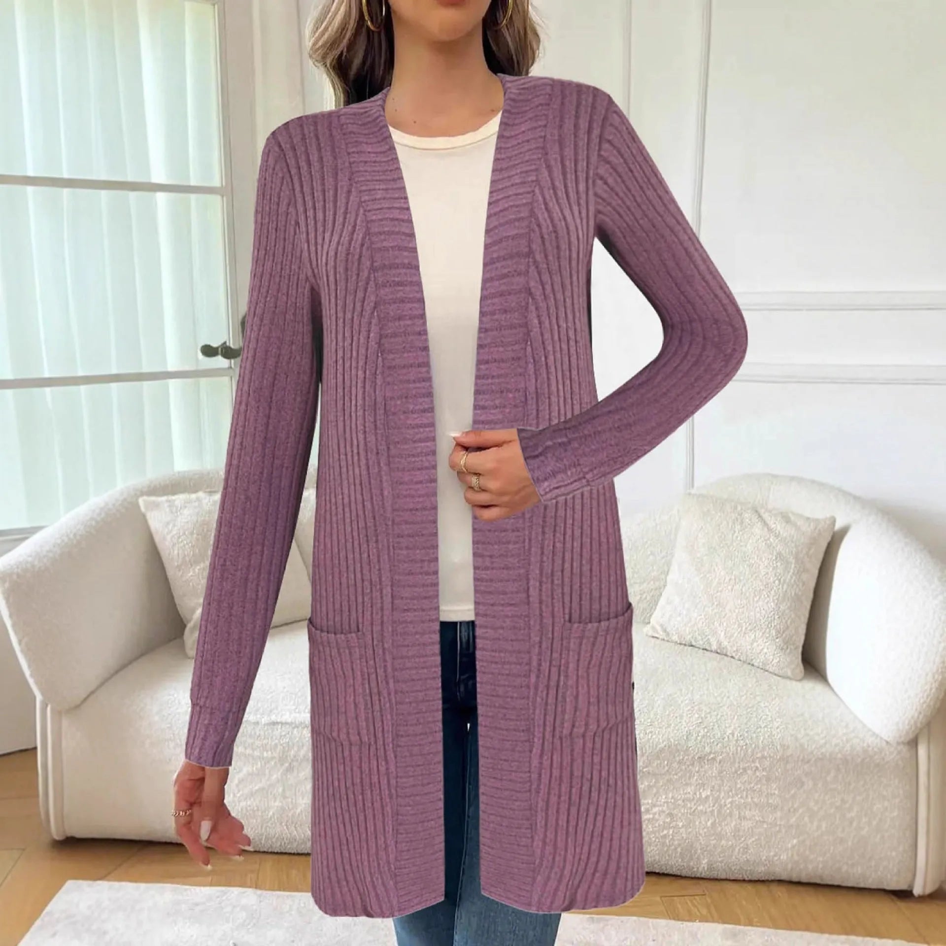 Long sleeve loose pocket knitted cardigan jacket in grey on a hanger.