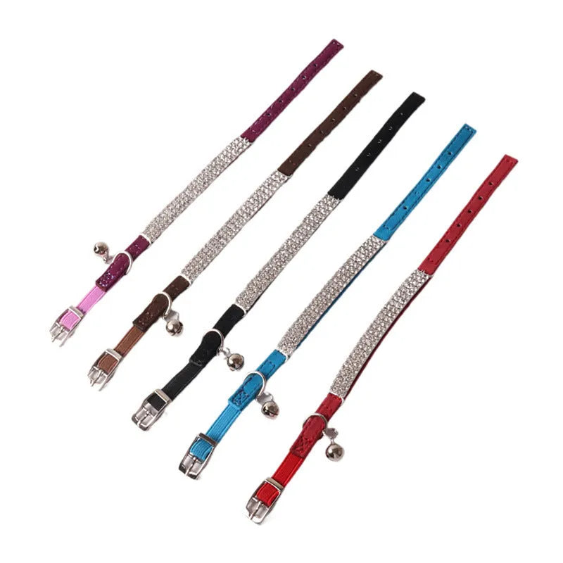 Flocked material cat collar with elastic buckle in assorted colours on a white background.