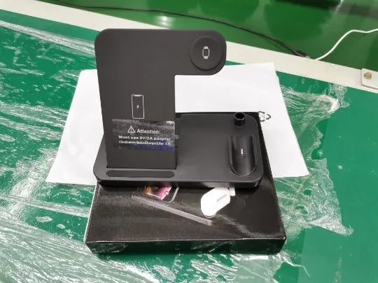 Folding 4-in-1 wireless charger showing iPhone, Apple Watch, and AirPods charging simultaneously in vertical stand orientation