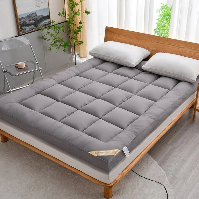 Thickened three-dimensional feather velvet mattress sheet in alpaca colour on a bed