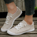 Women's creamy white low-top casual sneakers with fabric upper and rubber outsole on a neutral background