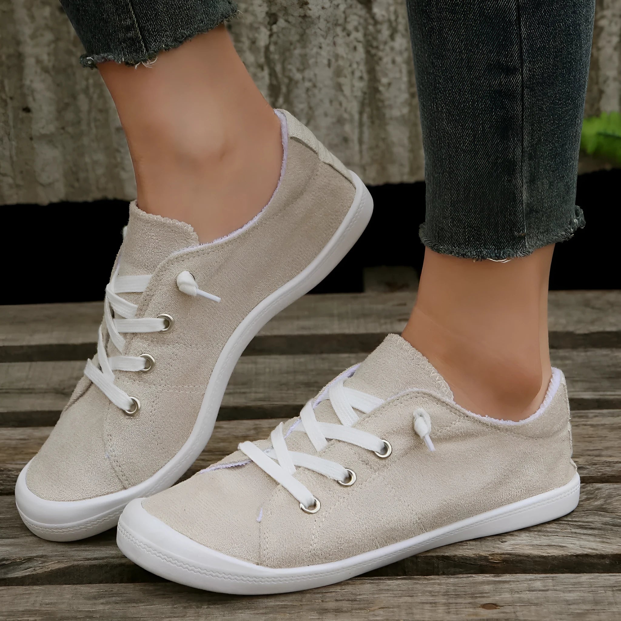 Women's creamy white low-top casual sneakers with fabric upper and rubber outsole on a neutral background