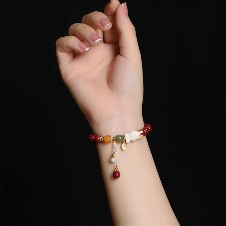 Natural cinnabar bracelet for women in purple-gold sand with rabbit motif, showing 8mm and 10mm bead size options.