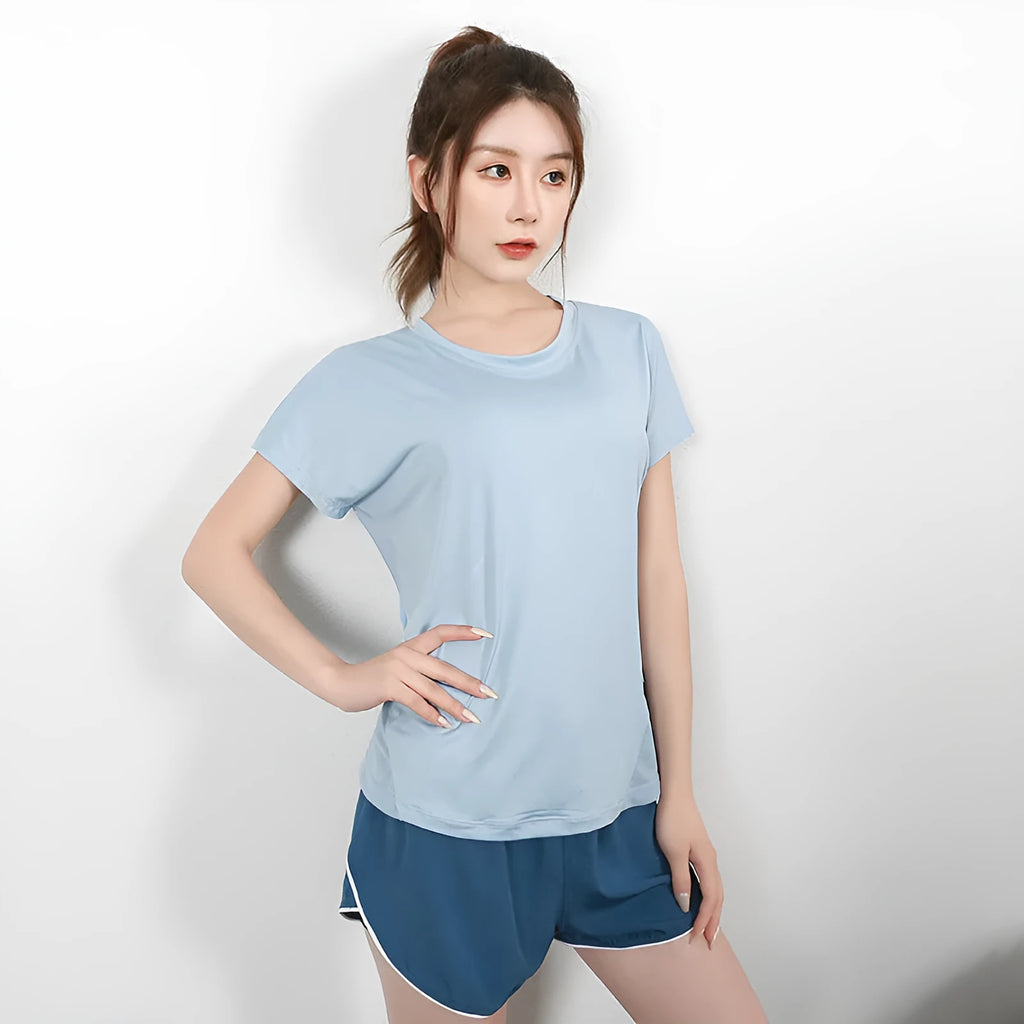 Women's short sleeve polyester sports t-shirt in pink, shown in a casual athletic style.