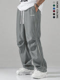 High street charging paratrooper pants for teenagers in straight leg style, available in multiple colours like black and dark green