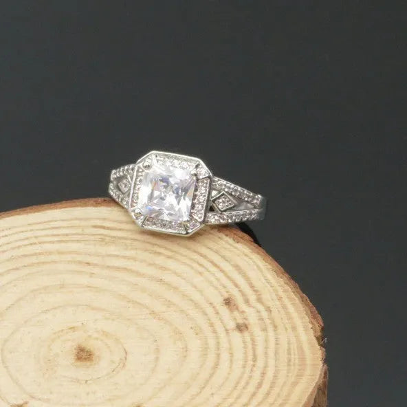 Geometric hollow design zircon ring in platinum-colour finish on copper, showing quadrilateral stone faceting