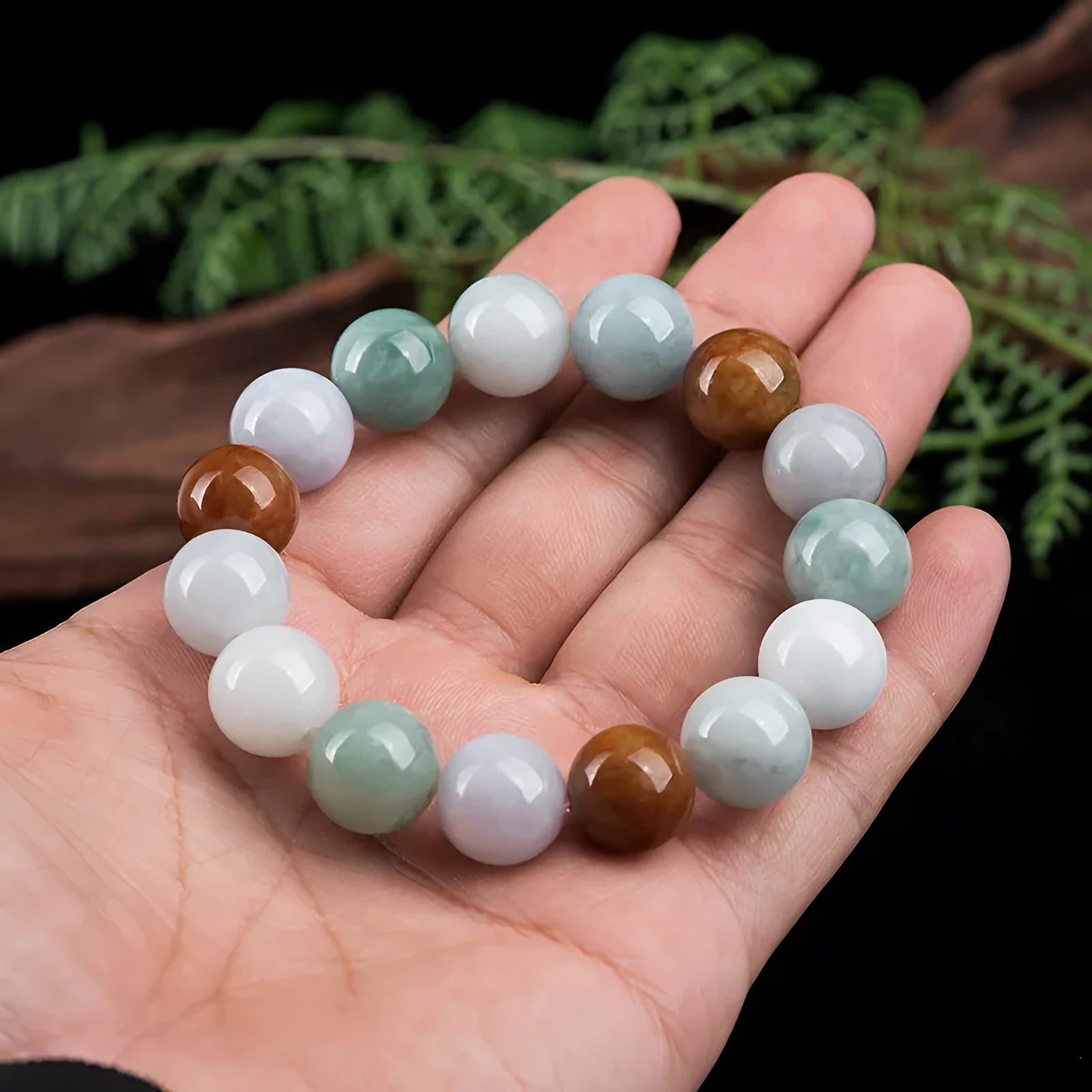 Women's natural Myanmar jade bracelet showing three colours in 13mm round bead design