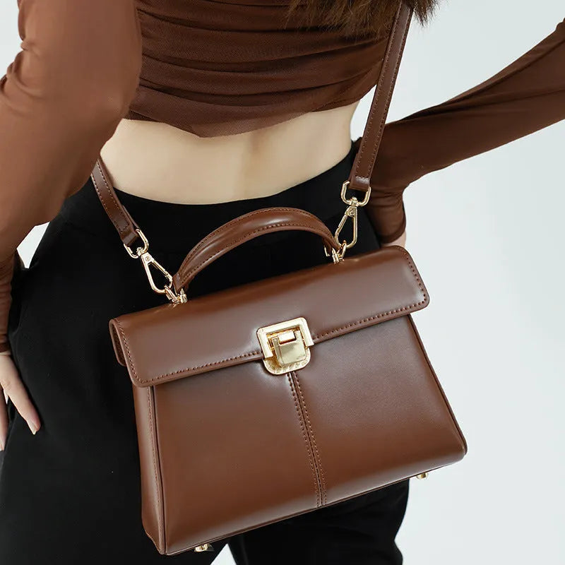 Women's black genuine leather shoulder bag with horizontal square shape and cover opening