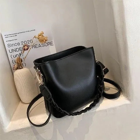 Retro brown bucket bag with weaving pattern, showing crossbody strap and underarm design