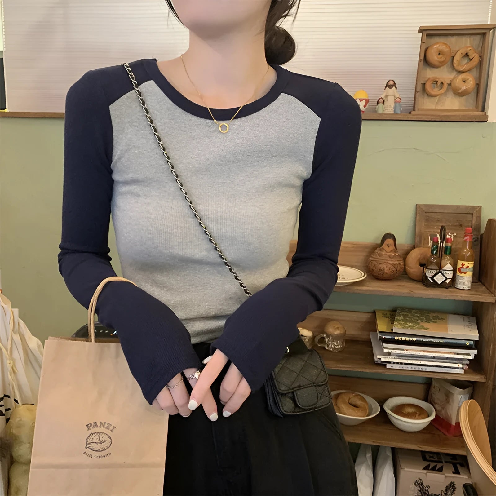 Women's dark blue slim fit casual top with long princess sleeves and embroidered front detail.