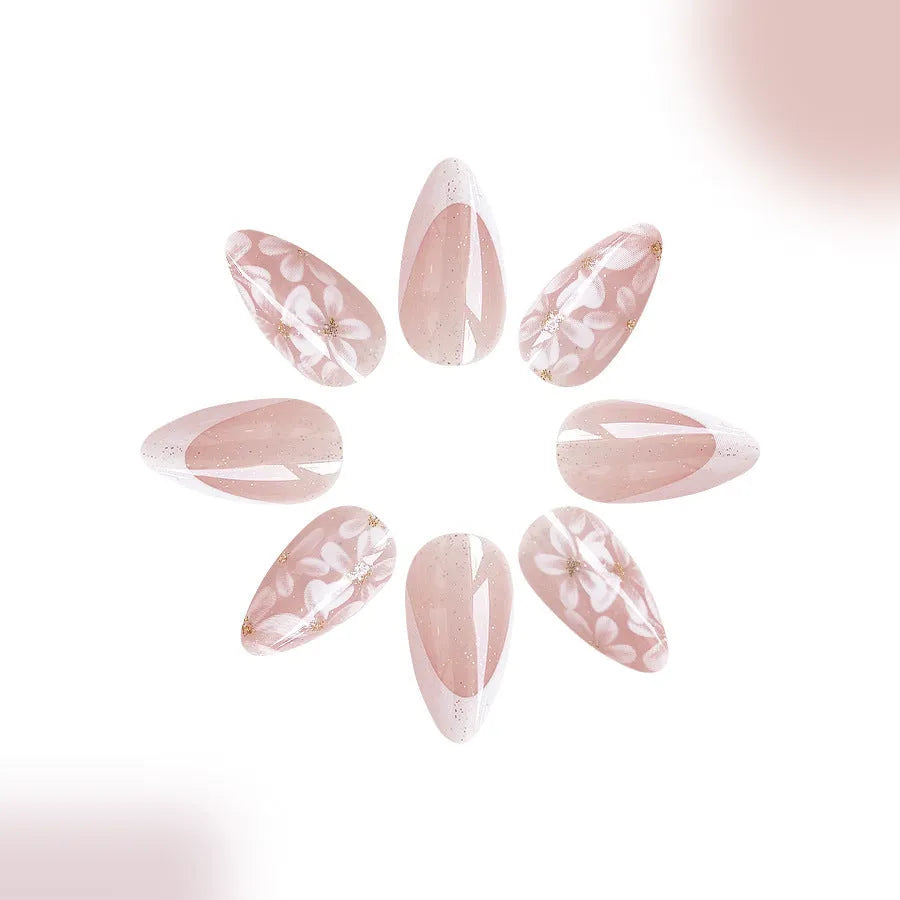 Glossy almond shaped press-on nails with French style white tips and glitter powder floral design in C625 pattern
