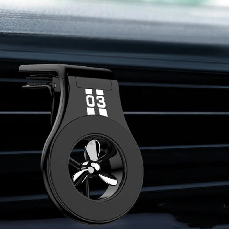 Black magnetic car air vent phone holder with adjustable mount and fragrance slice compartment.