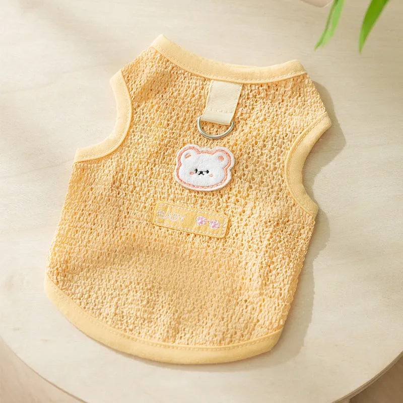 Blue knitted cat clothing with a bear patch, showing hollowed-out breathable design