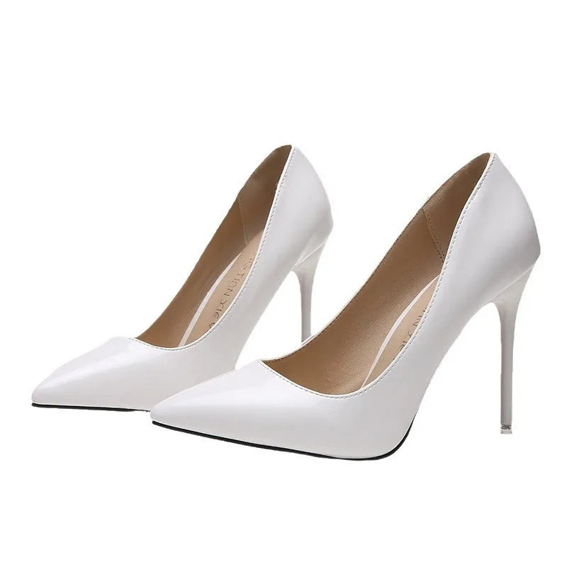 Women's nude stiletto heel pointed pumps in apricot colour with a buckle detail and rubber sole.