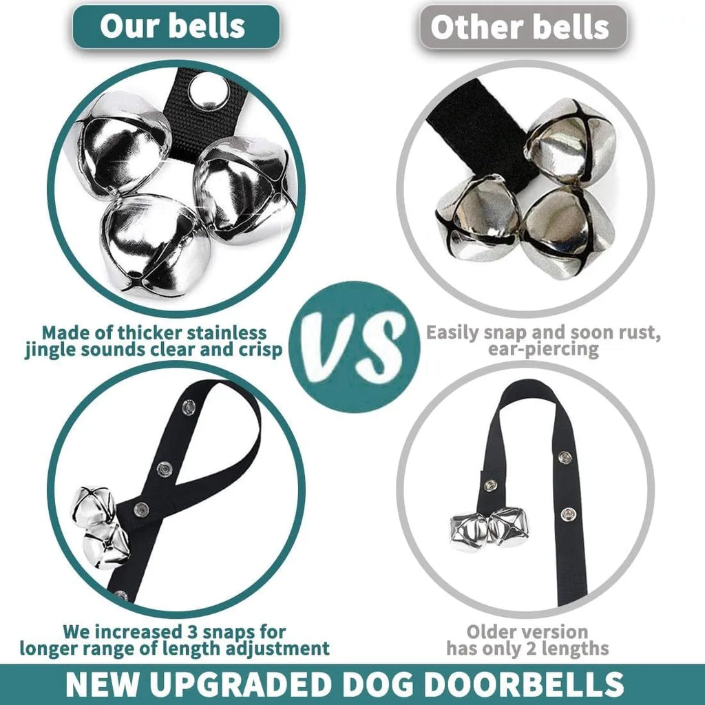 Silver metal dog training bells on an adjustable black nylon leash hanging from a door handle.