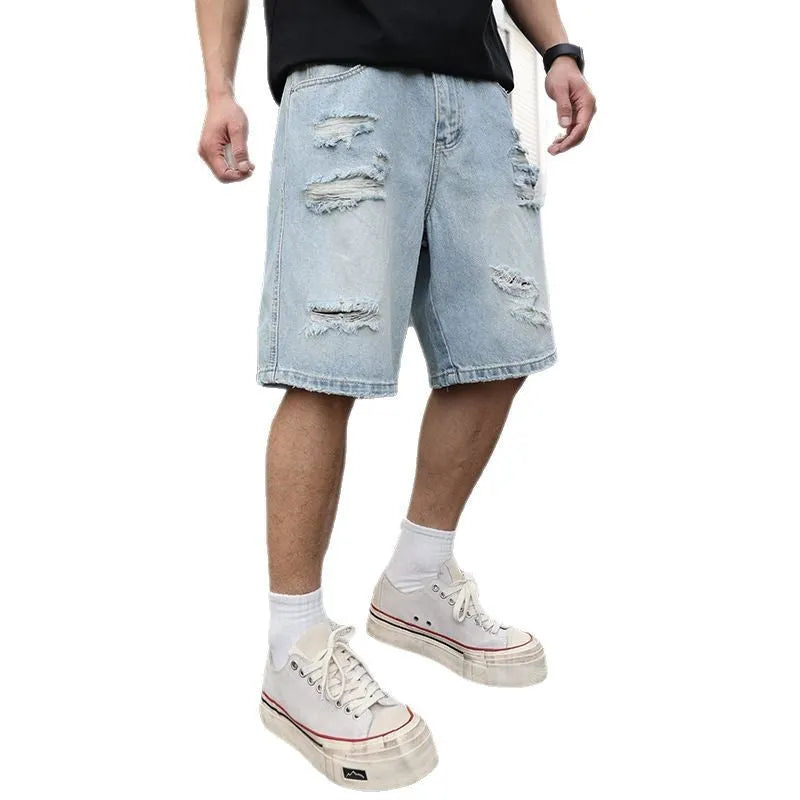 Light blue distressed denim shorts with ripped detailing and straight cut silhouette