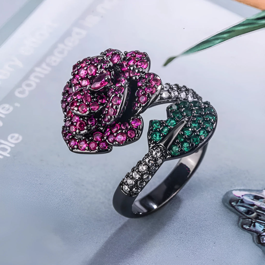 Gold-plated women's ring with a geometric black gold flower design and simulated red corundum detail.