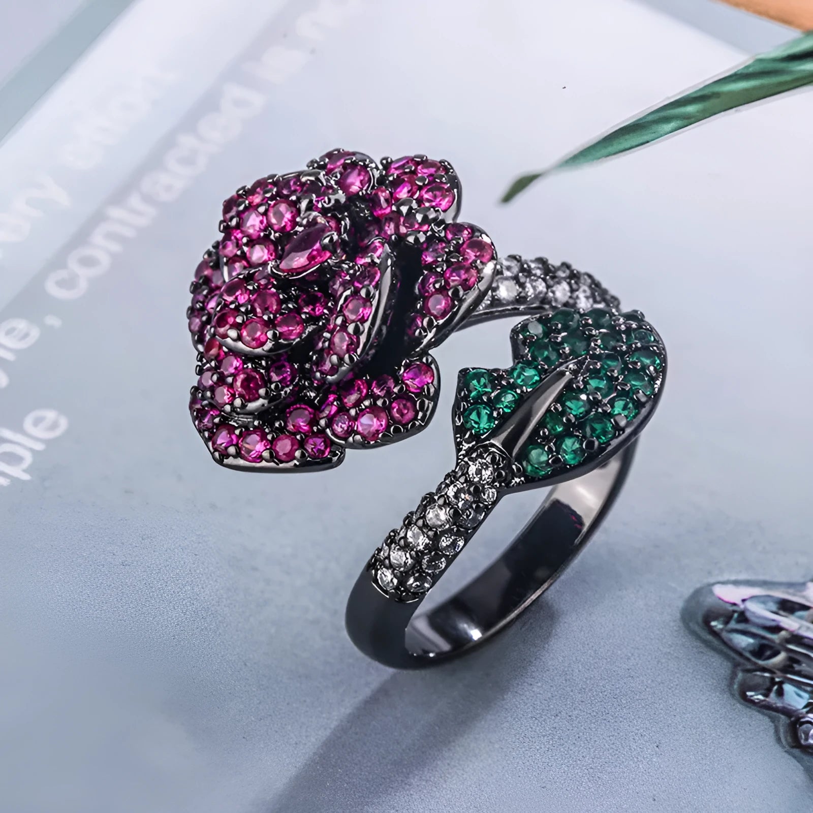 Gold-plated women's ring with a geometric black gold flower design and simulated red corundum detail.