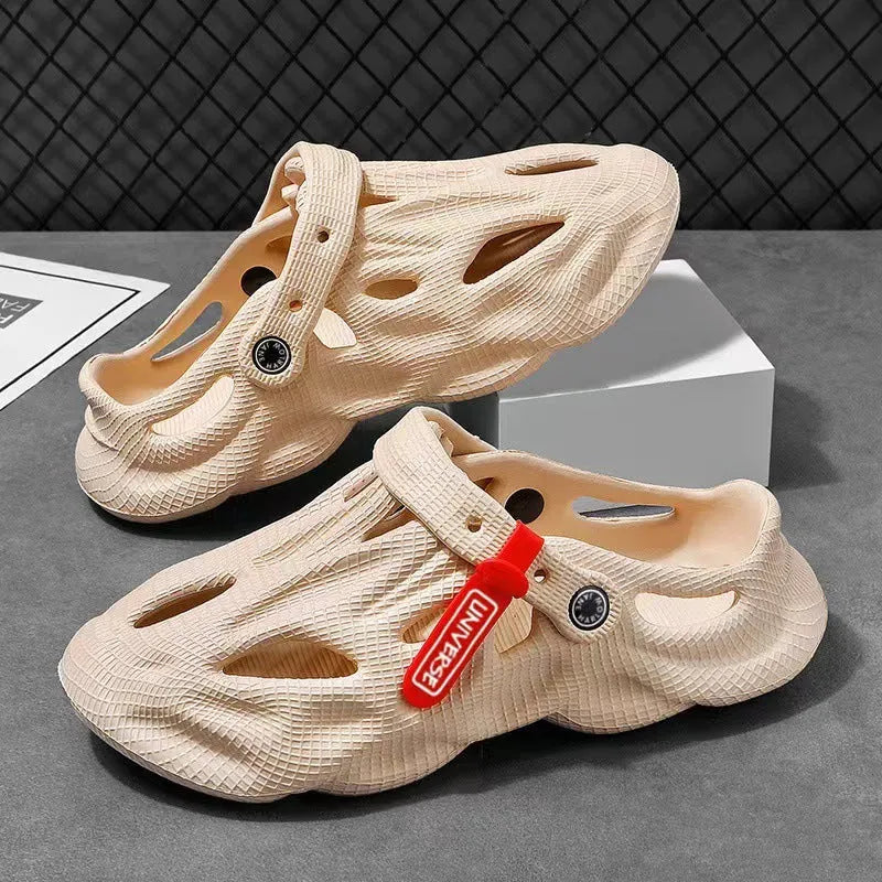 Pair of grey EVA foam closed-toe slippers on a sandy beach