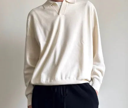 Pure wool lapel-collar polo sweater in a loose fit, shown in milky white.