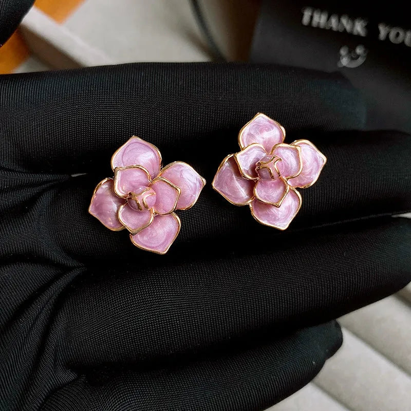 Purple and gold flower stud earrings with oil-spot glaze finish on copper bases