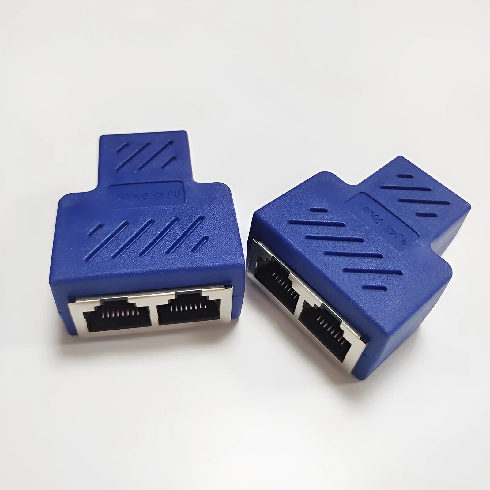 Two white RJ45 network cable splitter adapters showing three ports each.