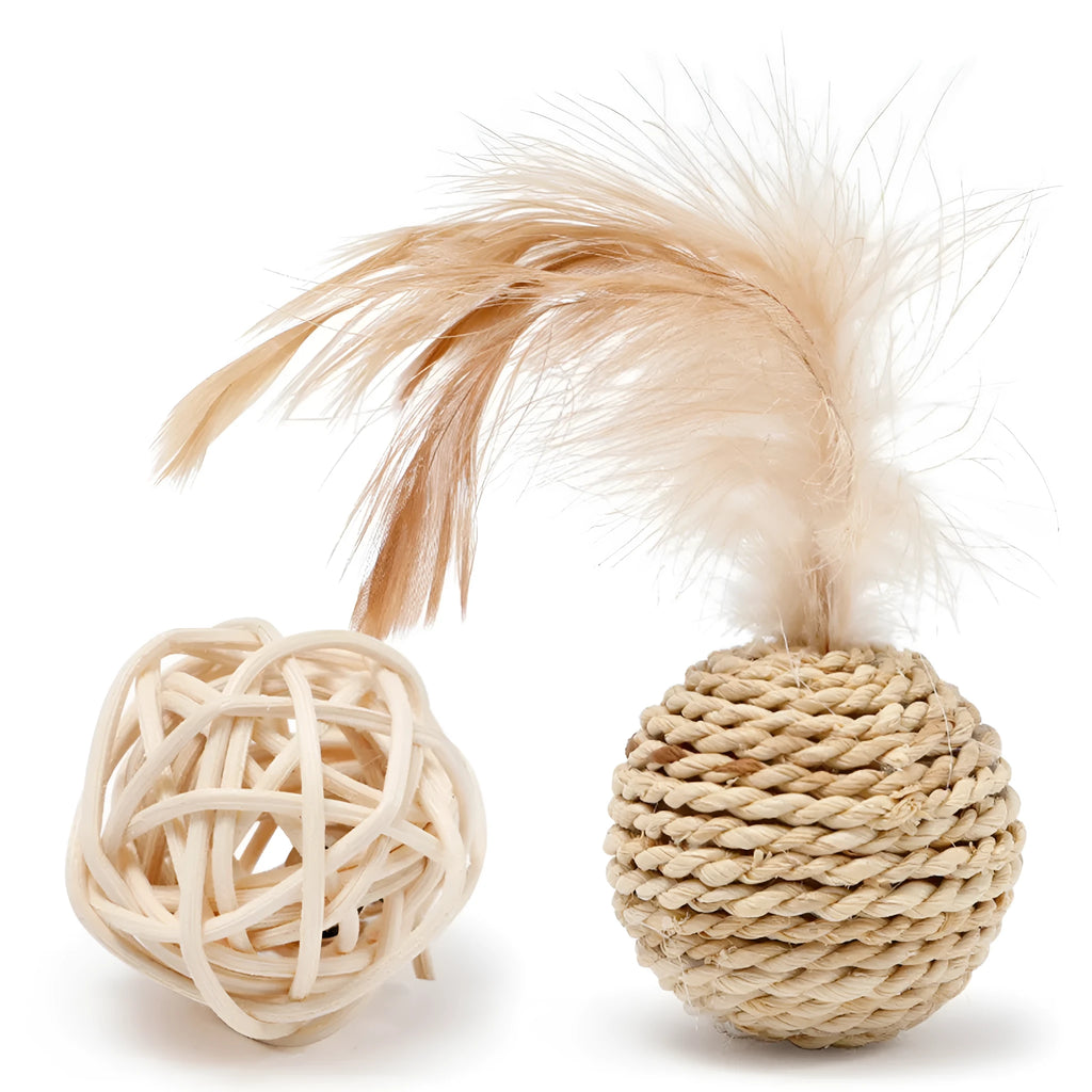 Two cat toys: a hollow rattan ball and a faux feather ball on a plain background