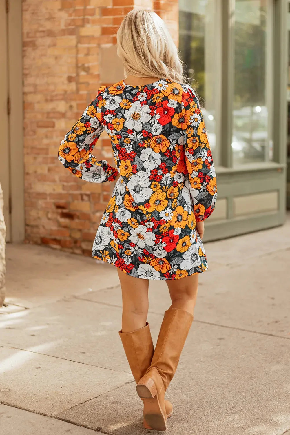 Orange floral print mini dress with striped lace on the V neckline and long sleeves.