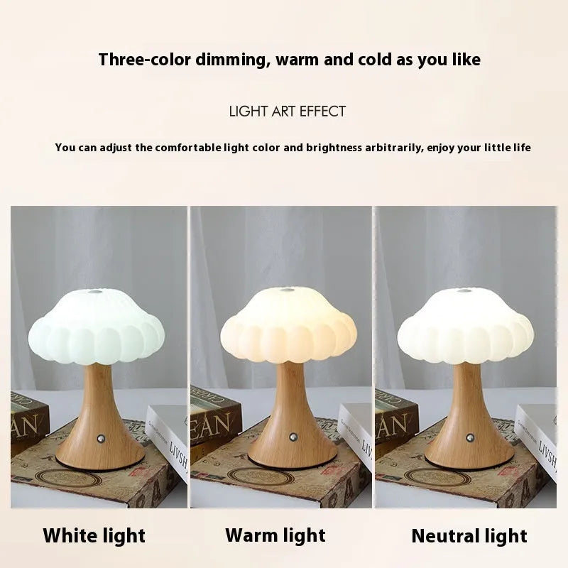 Small mushroom-shaped touch night lamp in wood grain colour on a table.