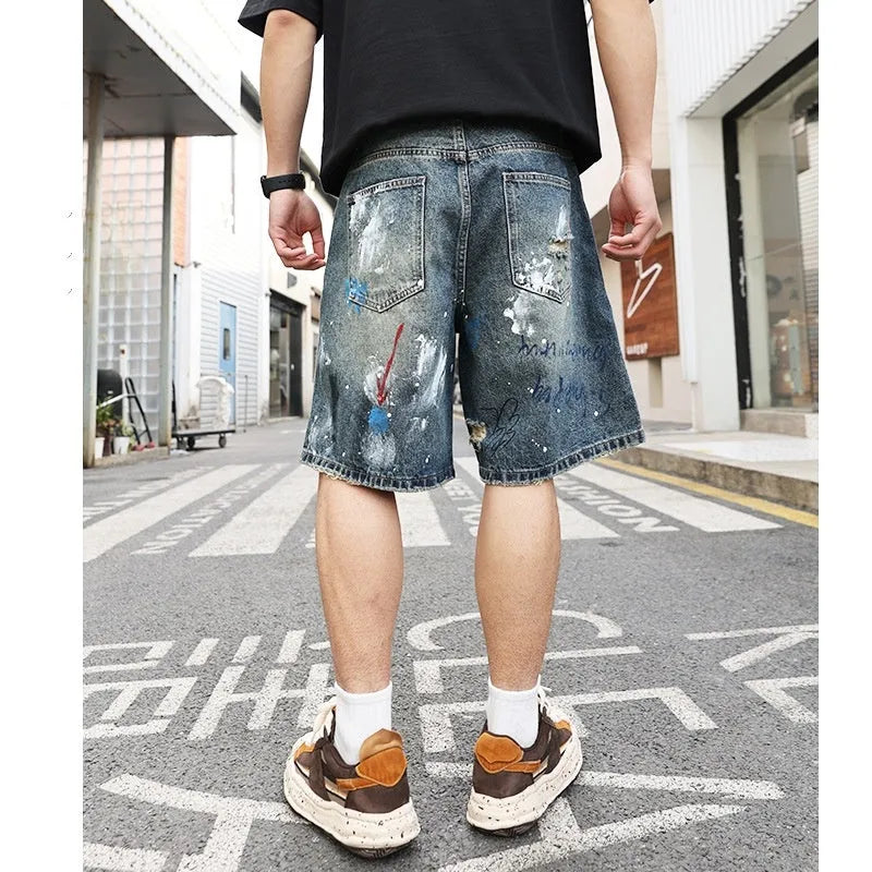 Men's blue ripped jeans shorts with graffiti details and straight leg opening