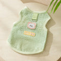 Blue knitted cat clothing with a bear patch, showing hollowed-out breathable design