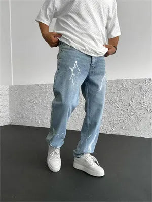Men's blue straight-leg cotton denim trousers with a wide-leg fit and five-pocket design on a neutral background.
