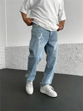 Men's blue straight-leg cotton denim trousers with a wide-leg fit and five-pocket design on a neutral background.