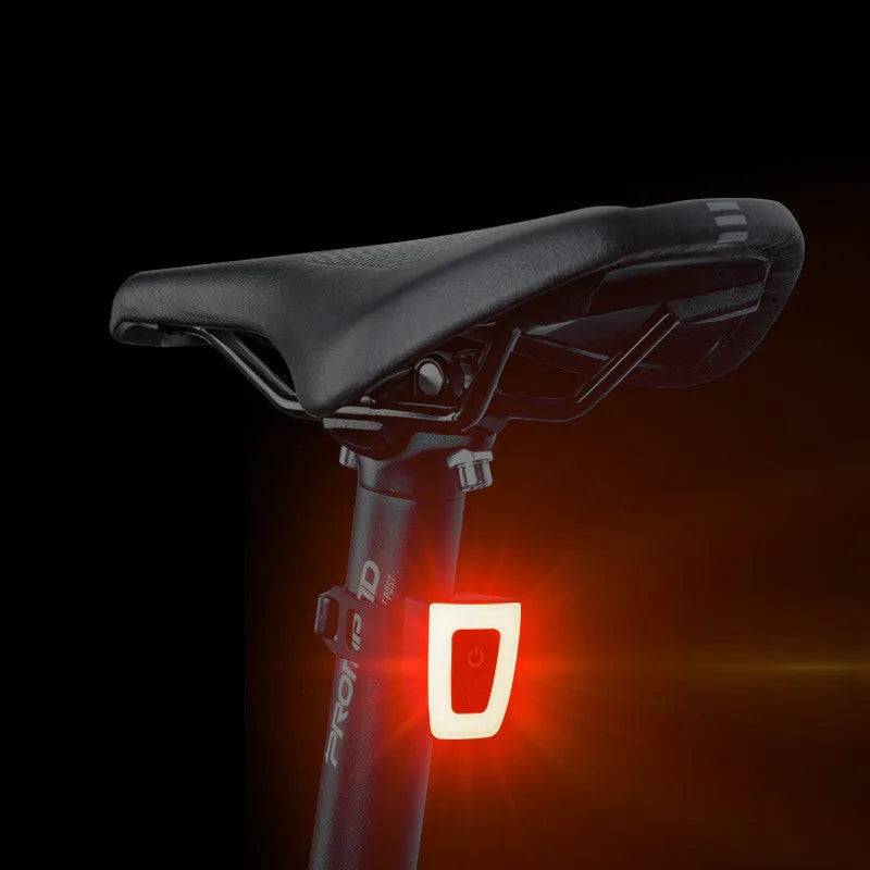 USB rechargeable bicycle taillight in black mounted on helmet with 3 lighting modes