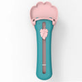 Green and pink plastic pet food squeezer feeder with a spoon-shaped dispensing end.