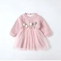 Baby girl pink velvet dress with long sleeves and mesh overlay, front view, sitting pose