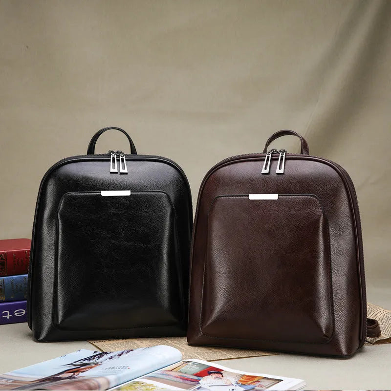 Women's fashion PU backpack in black with shoulder strap and top handle, casual daypack design.