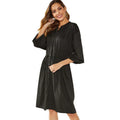 Women's black A-line midi dress with long sleeves, elastic cuffs, and a cinched belt.