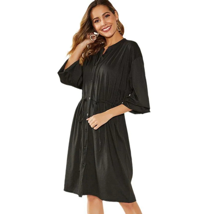 Women's black A-line midi dress with long sleeves, elastic cuffs, and a cinched belt.