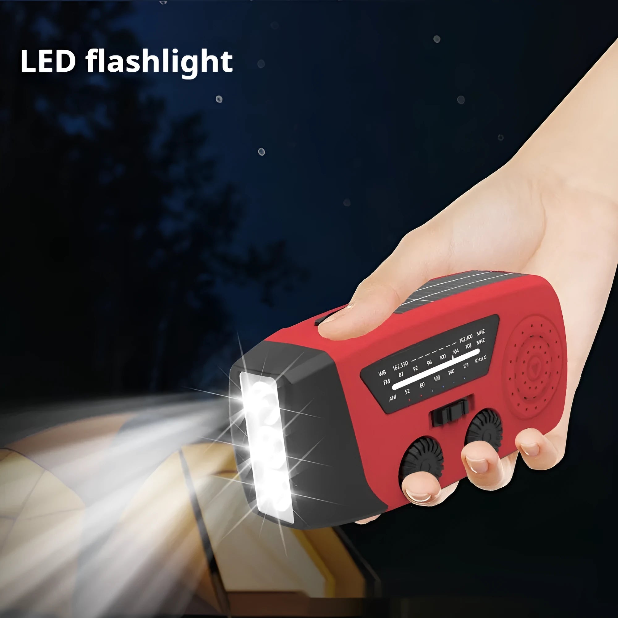 Red rechargeable emergency hand radio with torch, built-in speaker, USB port, and wrist strap.