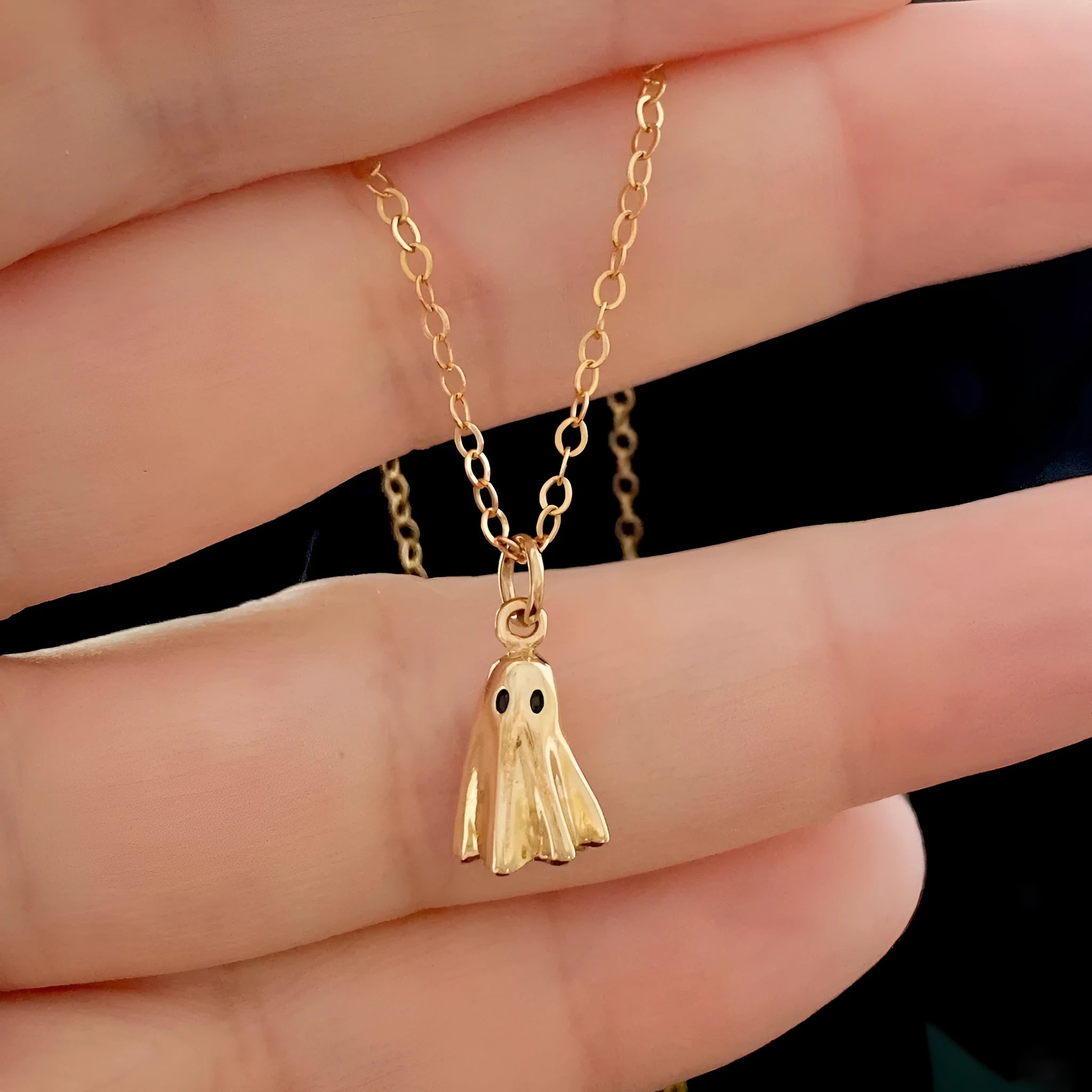 A ghost-themed pendant necklace on a twisted stainless steel chain, showing the titanium steel pendant detail.
